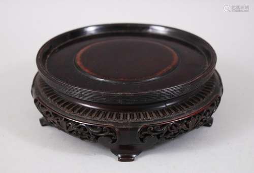 A 19TH CENTURY CHINESE HARDWOOD CARVED CIRCULAR STAND, the frieze of the stand carved and pierced