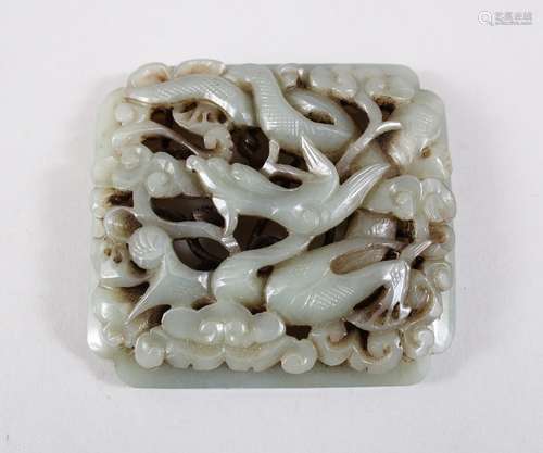 A GOOD CHINESE MING DYNSTY OR LATER CARVED JADE PLAQUE, carved to depict a dragon dog amongst