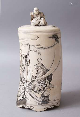 A FINE JAPANESE MEIJI PERIOD CARVED IVORY RAKAN / AHRATS LIDDED TUSK VASE, the body of the vase