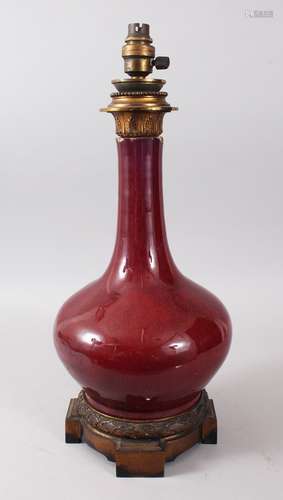 A GOOD 19TH CENTURY CHINESE ORMOLU MOUNTED SANG DE BOEUF BOTTLE VASE, the vase later converted to