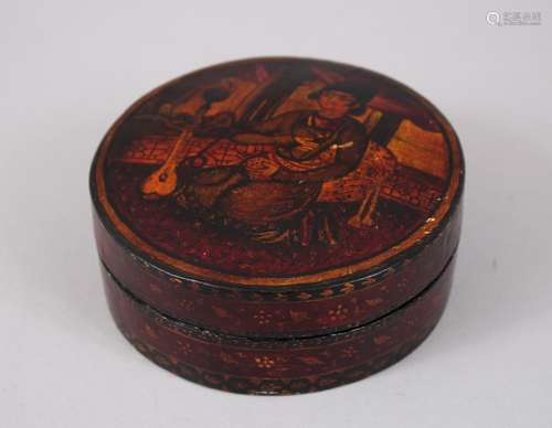 A 19TH CENTURY PERSIAN QAJAR LAQUER CIRCULAR BOX AND COVER, the lid with a seated man with a guitar,