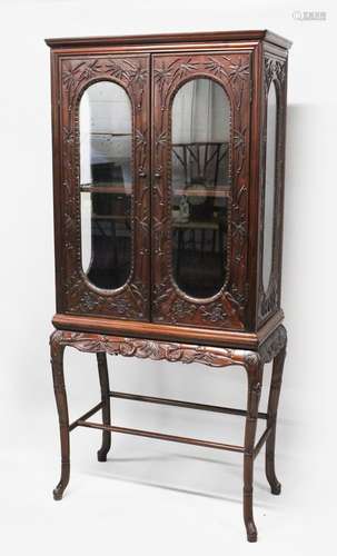 A GOOD 19TH CENTURY CHINESE HARDWOOD CARVED DISPLAY CABINET, the body of the cabinet carved in