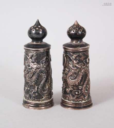 A GOOD PAIR OF 19TH CENTURY CHINESE SOLID SILVER DRAGON SALT SHAKERS, with moulded decoration of