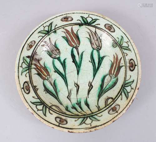 A 17TH CENTURY IZNIK POTTERY DISH - Ottoman Turkey, cream/green crackleglaze ground with