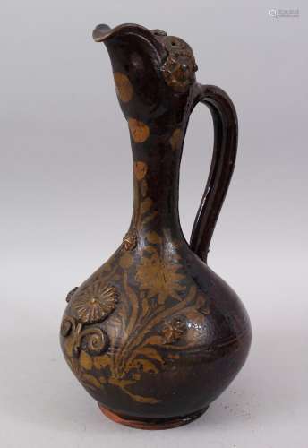 A 17TH CENTURY TURKISH OTTOMAN BROWN GLAZED EWER with floral decoration in gilt to the front, 36cm