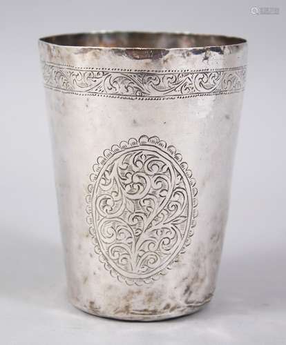 A 17TH-18TH CENTURY PERSIAN ENGRAVED BEAKER with three oval panels, 9cm high x 7cm diameter.