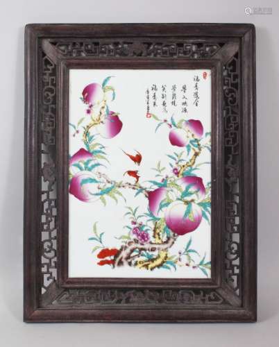 A GOOD CHINESE FAMILLE ROSE FRAMED PORCELAIN TILE, the tile well painted to depict scenes of peach