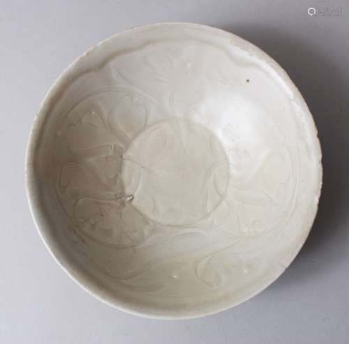 A GOOD CHINESE SONG DYNASTY MOULDED CERAMIC DISH, the centre of the dish with moulded / carved