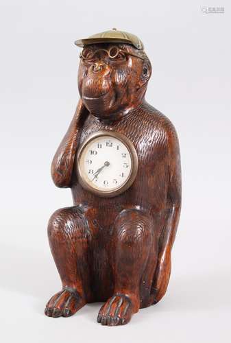 A BLACK FOREST CARVED WOOD MONKEY CLOCK AS A JOCKEY. 26cms high.