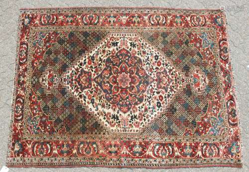AN OLD BAKHTIARI PERSIAN RUG 1920'S-1930'S, with a large diamond shaped motif and many other motifs.
