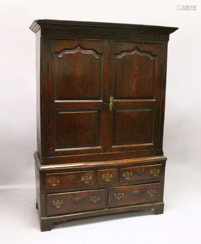 AN 18TH CENTURY OAK BACON CUPBOARD, with a moulded cornice, blind fret decorated frieze above a pair