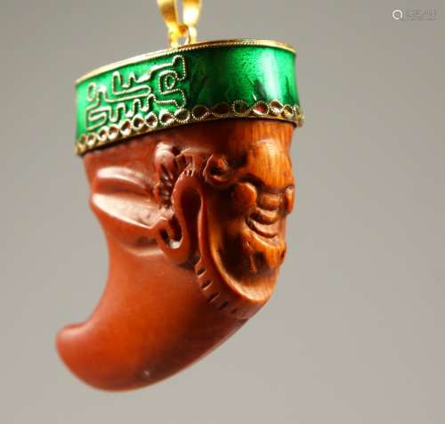A CARVED CLAW PENDANT.