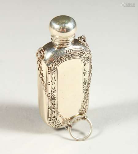 A STERLING SILVER ENGRAVED SCENT BOTTLE on a chain. 6cms long.