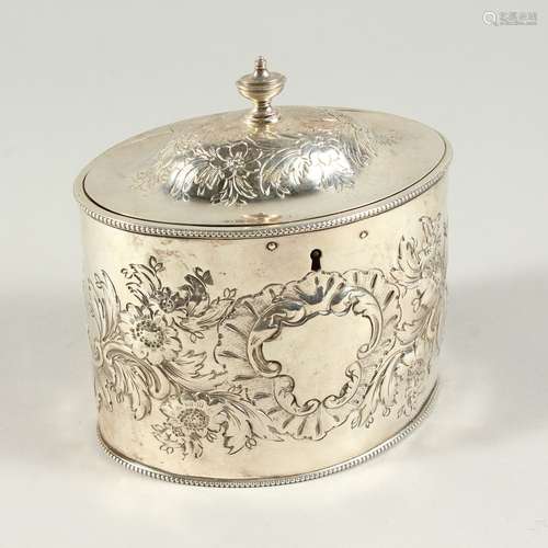 A GEORGE III OVAL TEA CADDY AND COVER with bead edge and floral repousse decoration. London 1804.