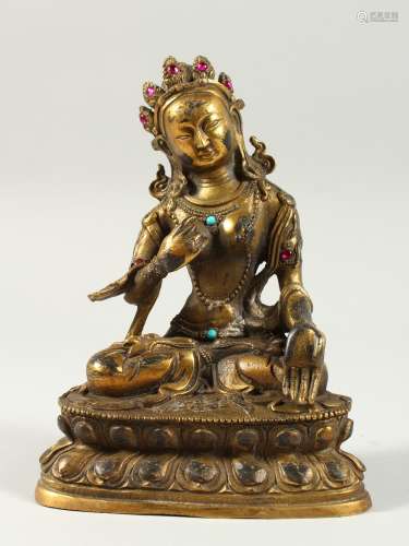 A CHINESE BRONZE GOD sitting cross legged, with turquoise stones. 6.5ins high.