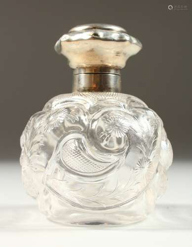 A VICTORIAN CRYSTAL GLOBULAR SCENT BOTTLE AND STOPPER by WILLIAM COMYNS, with flowers and scrolls.