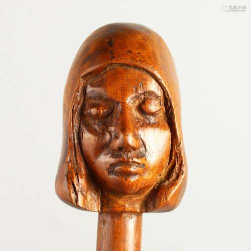 A 20TH CENTURY WALKING STICK, the handle carved as a head of a girl. 92cms long.