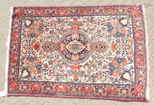 A PERSIAN BIDJAR RUG with a floral centre, motif and border. 5ft 3ins x 3ft 8ins.