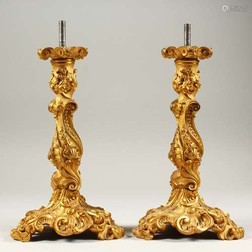 A PAIR OF ORMOLU LAMP BASES in the Rococo style. 26cms high.