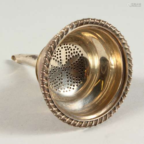 A GEORGE IV WINE STRAINER with gadrooned edge. London 1825. Maker William Bateman.