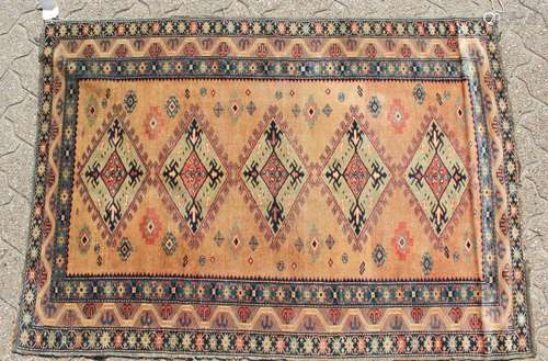 AN ARMENIAN RUG with five diamond shaped motifs and triple row border. 4ft 9ins x 3ft 4ins.