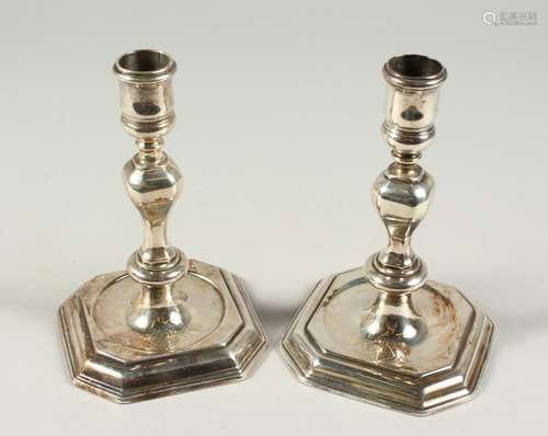 A VERY GOOD MATCH PAIR OF GEORGE II AND GEORGE II CAST SILVER CANDLESTICKS, 5.75ins high on