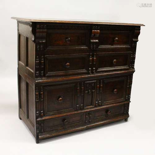 A 17TH CENTURY OAK FOUR DRAWER CHEST with plain three plank top, turned wood handles, on short feet.