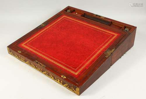 A GOOD LARGE REGENCY MAHOGANY BRASS BANDED WRITING BOX, with leather writing panel and two inkwells.