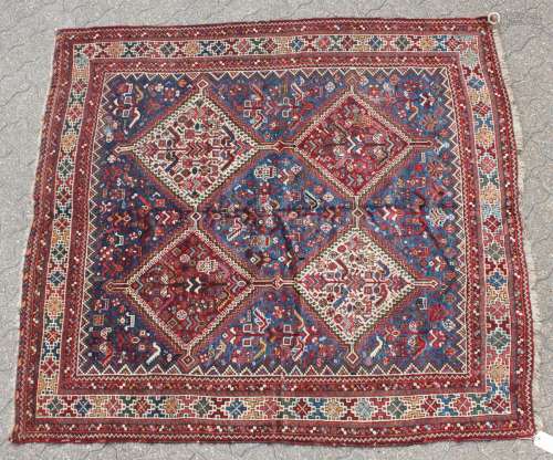 A PERSIAN QASHQAI TRIBAL RUG with four large diamond shaped motifs. 6ft x 6ft.