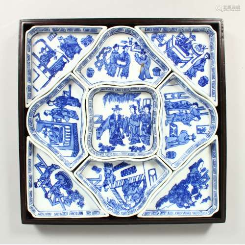 A CHINESE PORCELAIN BLUE AND WHITE HORS D'OEUVRES NINE PIECE SET in a fitted mahogany case. 11ins