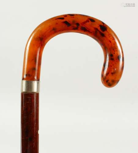 A WALKING STICK with faux-tortoiseshell handle and silver band. Birmingham. 2ft 1in long.