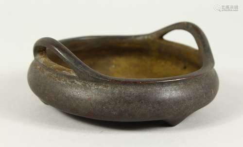 A CHINESE BRONZE CIRCULAR TWO HANDLED CENSER with six character impressed mark. 4ins diameter.