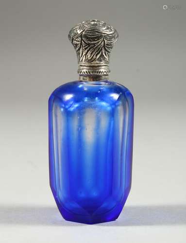 A VICTORIAN BLUE OVERLAID SCENT BOTTLE with silver top. 8cms high x 8cms long.