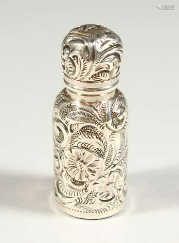 A SMALL VICTORIAN SILVER CASED SCENT BOTTLE AND STOPPER with repousse decoration. Birmingham 1876.