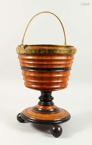 A DUTCH CIRCULAR WOODEN BUCKET ON STAND with brass handle and liner. 1ft 3ins high.