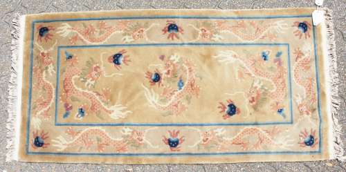 A CHINESE WOOL RUG with Dragon design in blue and green. 4ft 7ins x 2ft 3ins.