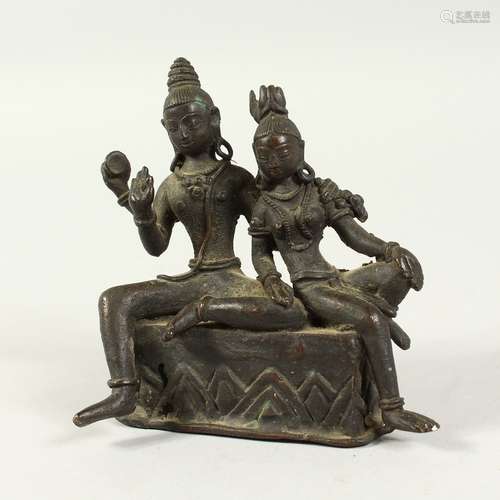 A SMALL INDIAN BRONZE OF TWO GODS. 4ins high.