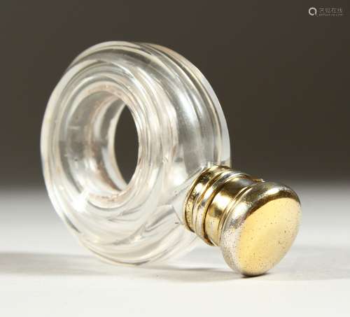 AN EDWARDIAN GLASS SCENT BOTTLE with a hole in the centre, with silver cap and plain glass