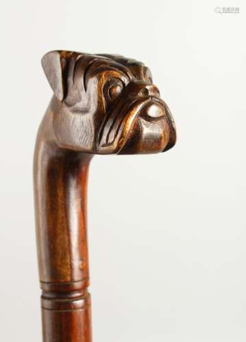 A 20TH CENTURY WALKING STICK, the handle carved as a bulldog. 92cms long.