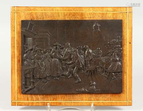 A CONTINENTAL RELIEF CAST BRONZE PLAQUE, depicting an interior scene with figures. 21cms wide x