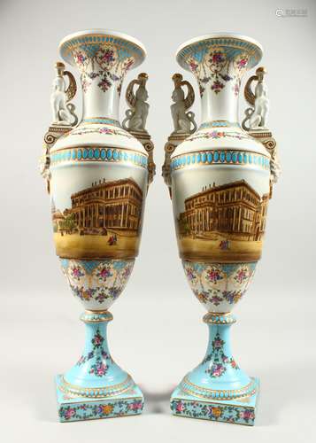 A PAIR OF TWO HANDLED URN SHAPED VASES painted with a continuous scene of a city centre with