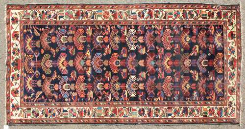 A PERSIAN BAKHTIARI CARPET with numerous designs on a blue ground. 9ft 10in x 5ft 0