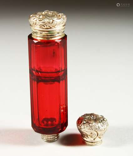 A GOOD VICTORIAN RUBY FACET CUT GLASS SCENT BOTTLE with repousse silver top. 9.5cms long.