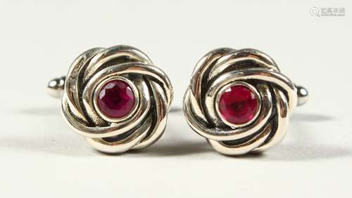 A PAIR OF SILVER RUBY SET KNOT CUFFLINKS.