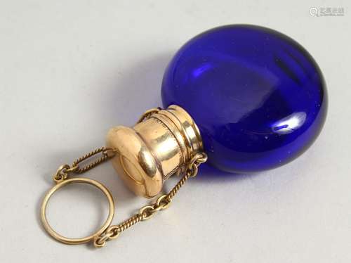 A 19TH CENTURY BRISTOL BLUE CIRCULAR SCENT BOTTLE with gilt cap and chain. 5cms diameter.