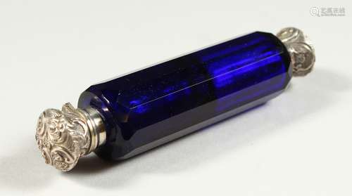 A VICTORIAN BRISTOL BLUE GLASS FACET CUT DOUBLE ENDED SCENT BOTTLE with repousse silver caps. 11.