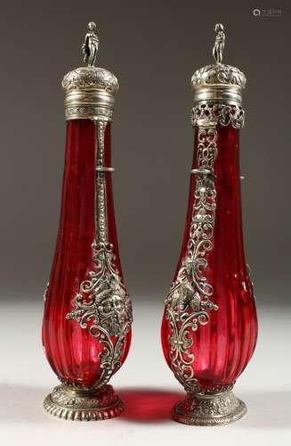 A VERY GOOD PAIR OF 19TH CENTURY CONTINENTAL RUBY GLASS SILVER MOUNTED SCENT BOTTLES, the silver