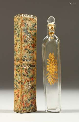 A GOOD 19TH CENTURY GLASS GILT DECORATED SCENT BOTTLE AND STOPPER. 11cms long, in a paper box.