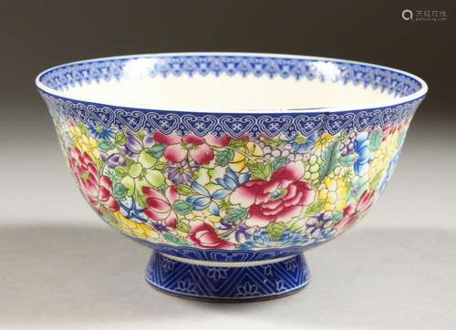 A CHINESE CIRCULAR PORCELAIN BOWL with blue border, the centre and sides with flowers in coloured