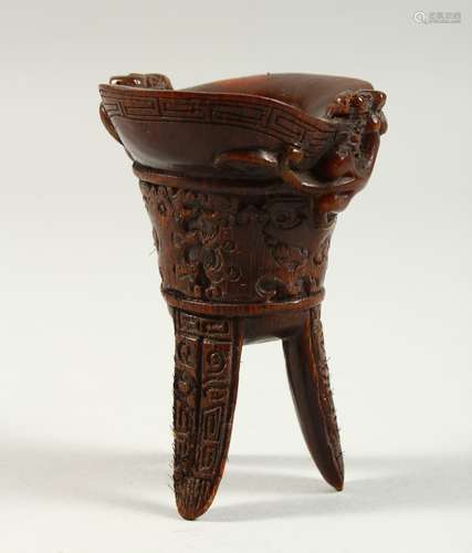 A HORN LIBATION CUP on three curving legs. 4.5ins high.